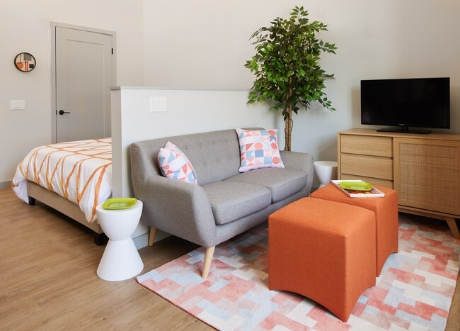 A studio apartment with designated bedroom and living spaces