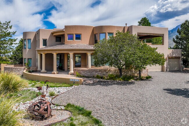 Multi story home with columns and metal art are a welcome sight in Foothills North.