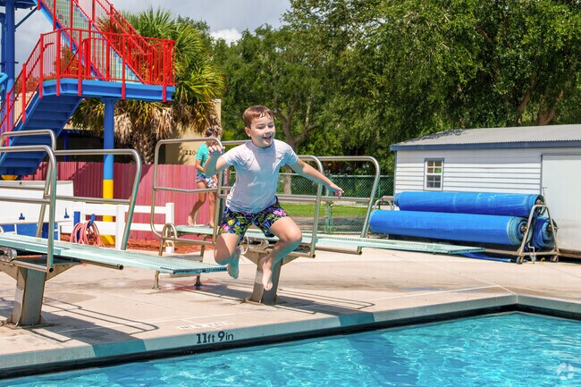 A young boy leaps off the diving board at Bob Makinson Aquatic Center in Mill Slough.