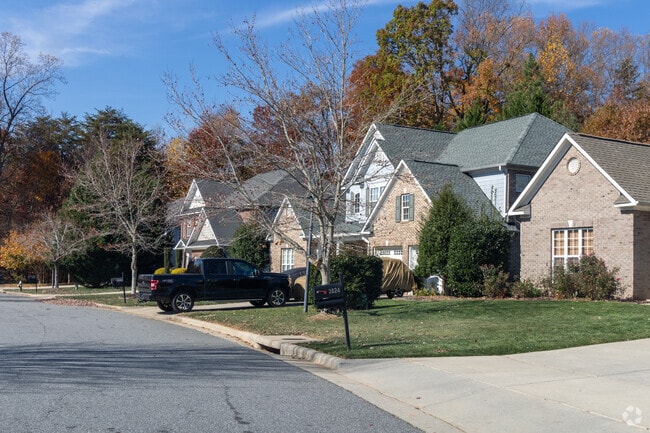 Houses are surrounded by large trees and a well-kept gardens in Spicewood.