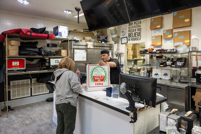 Rougemont neighborhood residents enjoy eating pizza at Roma's Pizza.
