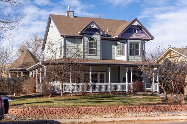 This Victorian style home in Sterne Park features a large yard and a covered porch.