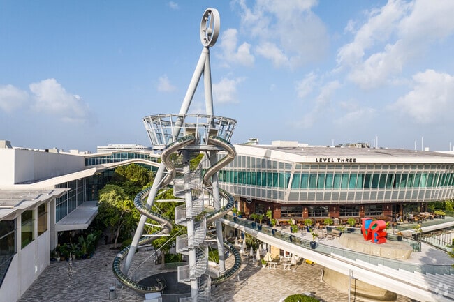 Ojus locals enjoy the waterslide and colorful sculpture in the heart of Aventura Mall.