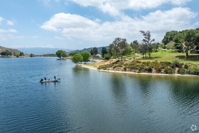 A family drifts along the lake while fishing on a beautiful Saturday afternoon in Castaic.