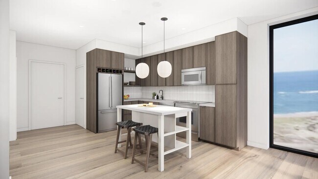 Gourmet kitchens with quartz countertops, custom cabinetry, and tile backsplash at Modera Revere Beach in Revere, MA.