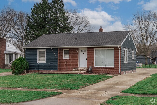 This Waynesburg ranch house with brick flair has a small front yard.