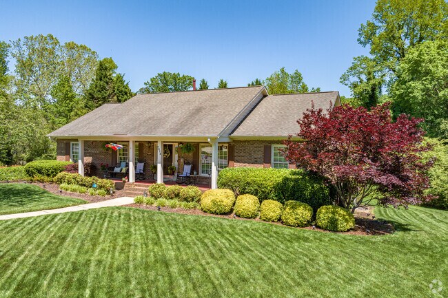 In Johnson Street Park, a Side-Gabled Brick ranch boasts a covered front porch.