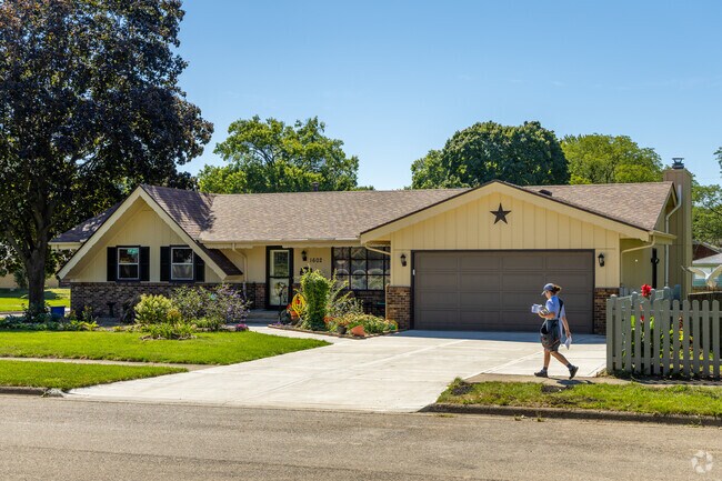 A postal worker delivers mail in the neighborhood of Halsted Road.