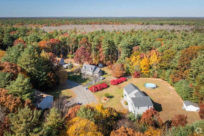 Wades Corner, MA glows in peak fall colors from a scenic overhead view.