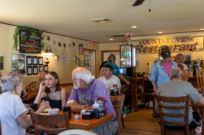 The Country View’s wood-paneled dining room welcomes early risers in Greenland.