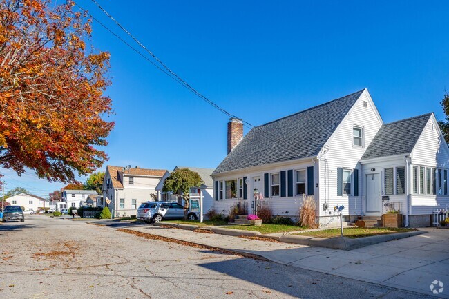 Cape Cod homes in Knightsville feature small yards and sidewalks along quiet residential blocks.