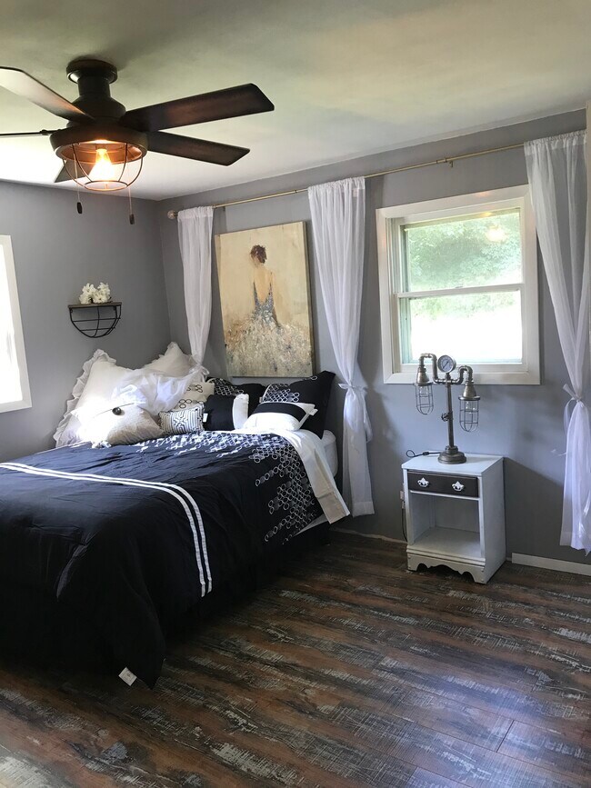Second bedroom. Flooring pictured runs throughout this entire apartment villa. Completely remodeled, brand new mattress and luxurious bedding.