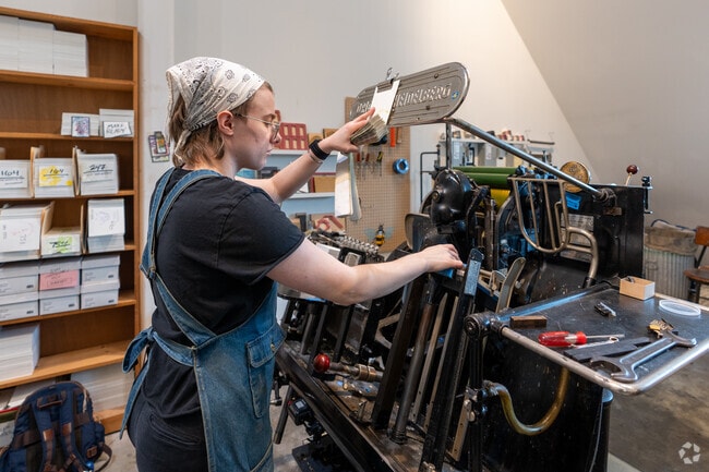 Alanah, a letterpress printmaker at Smudge Ink near Boxborough, prints greeting cards.