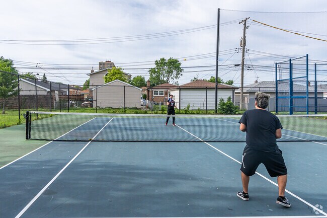 Friends play a friendly pickleball game at the courts in Rainey Park.