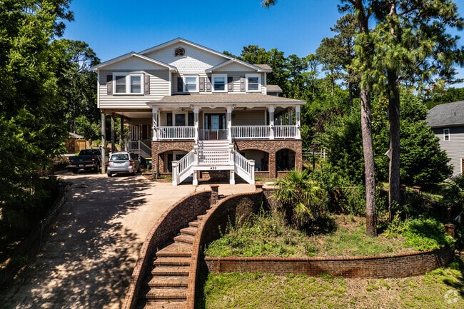 A waterfront home in Colington Harbour boasts a grand staircase leading to panoramic views.