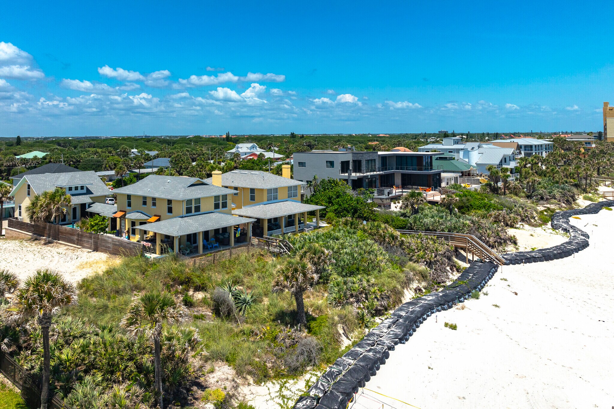 This row of spacious Coronado Beach homes enjoy stunning ocean views as they sit along the sand.