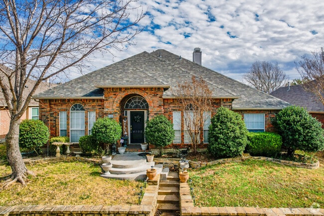 Single family brick homes sit on well-maintained lawns.