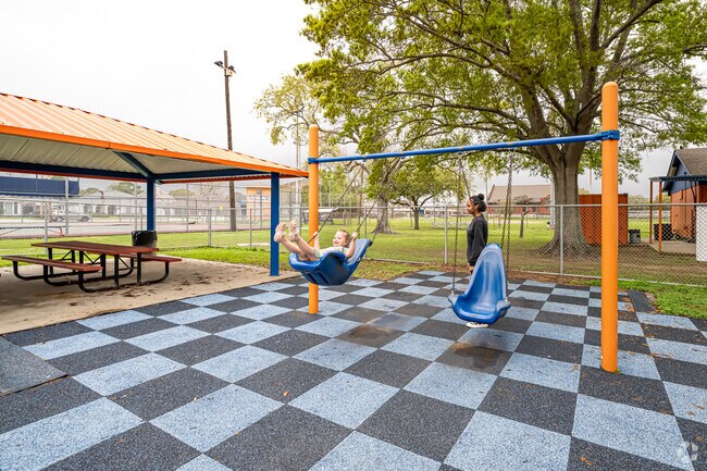 Enjoy swinging at Johnny Bright Playground.