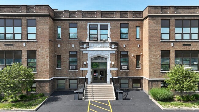 Stairs leading up to front doors of school.