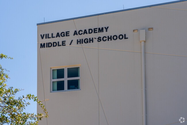 Village Academy Middle/High School sign on exterior of building.