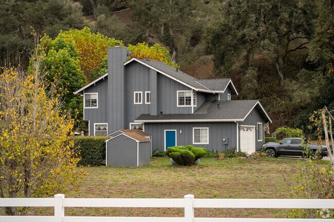 Nestled peacefully amidst nature, this two-story house whispers stories of tranquility and charm