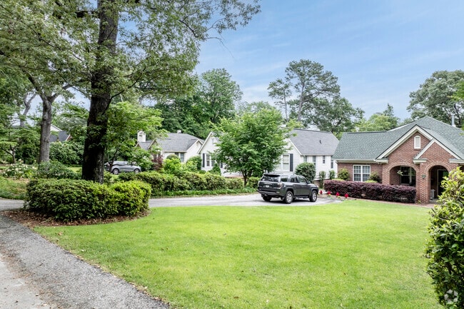 Mature trees and green lawns characterize this area.