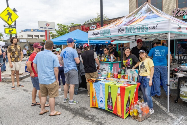 Servers pose at one of several food vendors along the Tucker Day main strip.