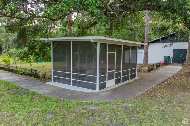 Students eat outside in the screened pavilion at Laniakea Montessori School.