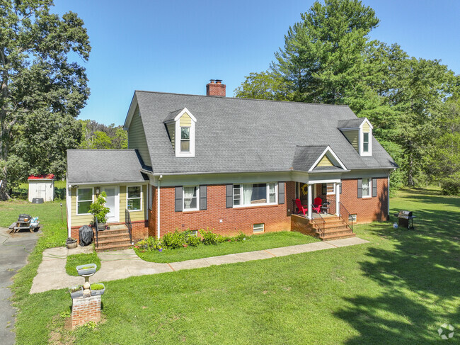 A brick raised ranch home with dormer windows in Cismont.