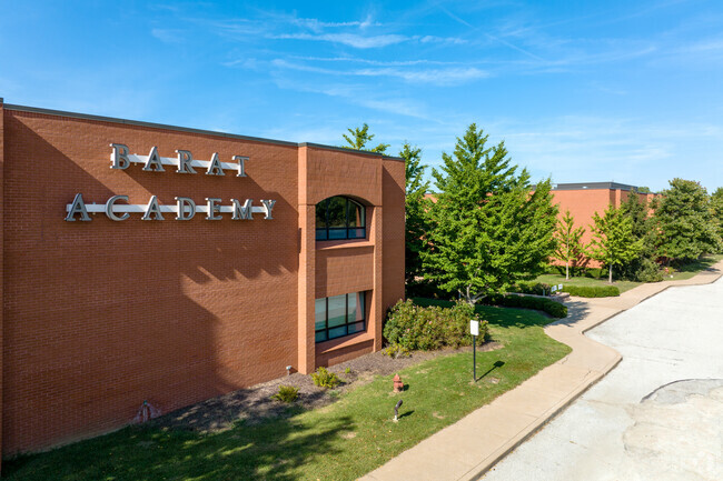Front of school has an emphasis on building sign in Barat Academy.