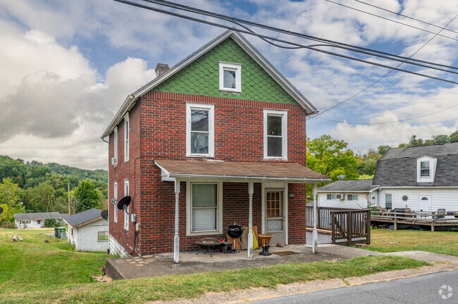 A four-square-style home stands on a street in Jerome Park.