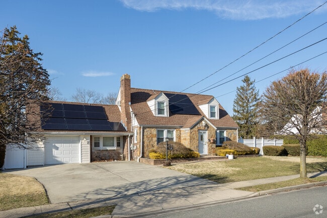Brick capes with manicured lawns are frequently seen in Hempstead.