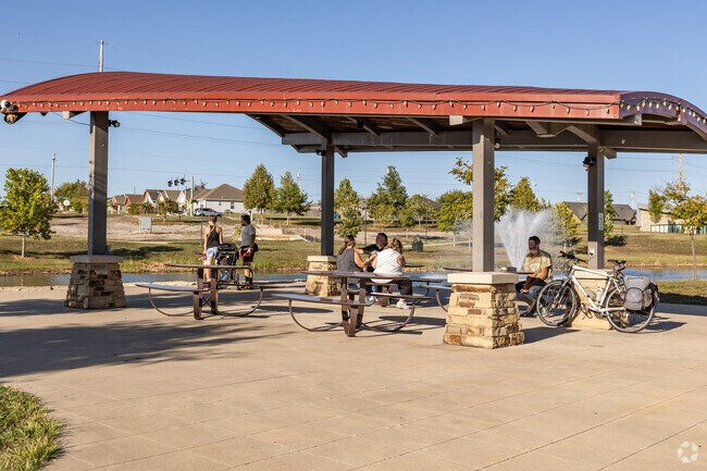 Residents gather under a pavilion at Mercy Park and enjoy views of the pond.