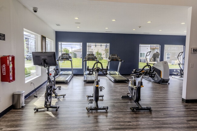 The fitness center is equipped for full-body workouts, including a Peloton bike.