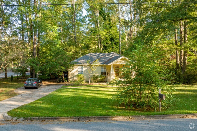 Tall evergreens line the narrow neighborhood streets and cul-de-sacs of Pine Hills.
