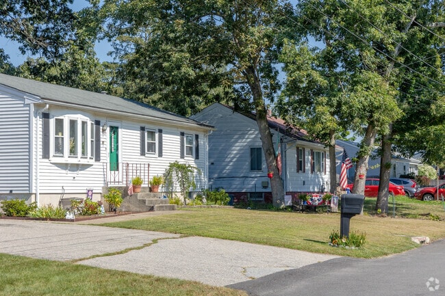 A vibrant row of ranch homes in Hillsgrove blends nature with festive seasonal charm.