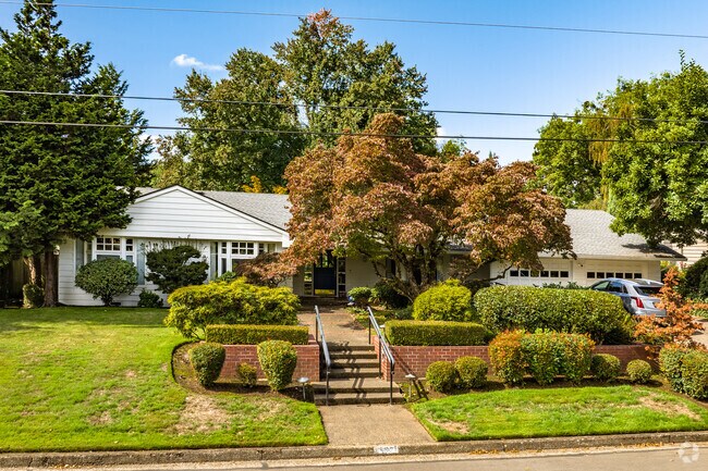 A ranch style home with large trees in the Cal Young neighborhood.