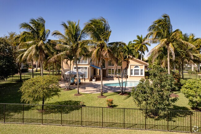 Palm trees adorn this beautiful home in the Robbins Park neighborhood of Davie, FL.