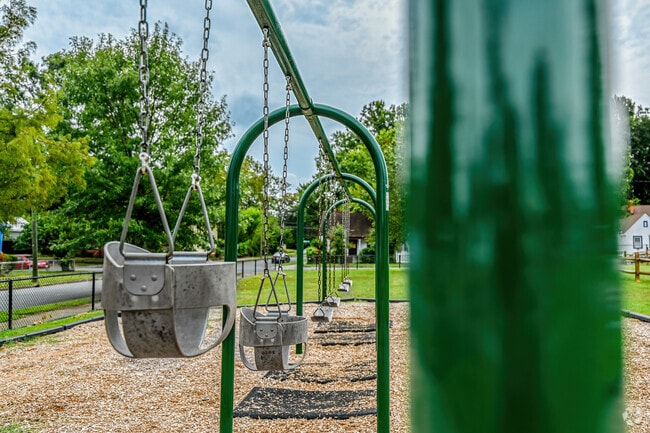 A swing set in the Oak Grove playground is fun for children of all ages and sizes.