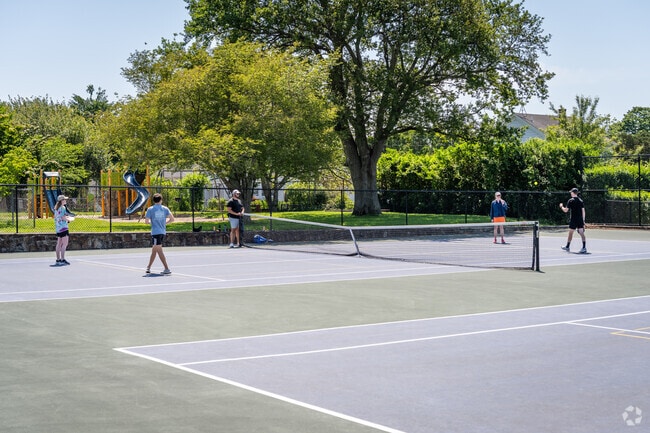 Friends are enjoying a round of pickleball at Vernon Park Tennis Courts in Eustis, RI.