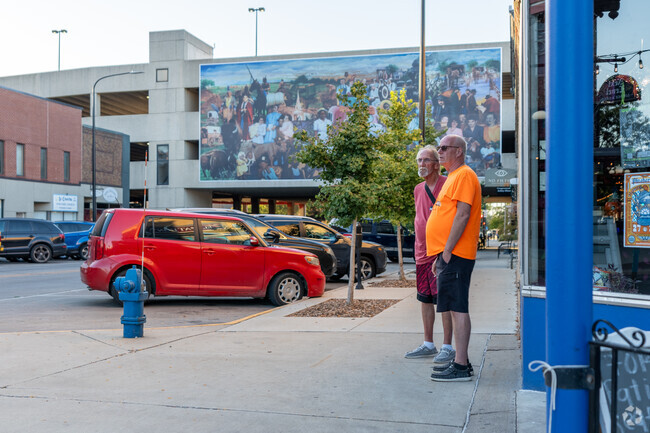 Friends stand on the street in downtown Waterloo on Lafayette St.