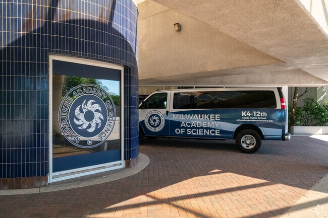 A vehicle in front of Milwaukee Academy of Science in Avenues West has school branding.