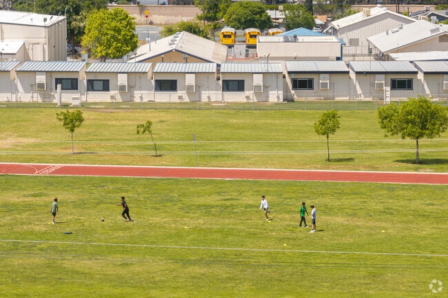 A group of soccer players utilize the Earlimart Middle School track for practice.