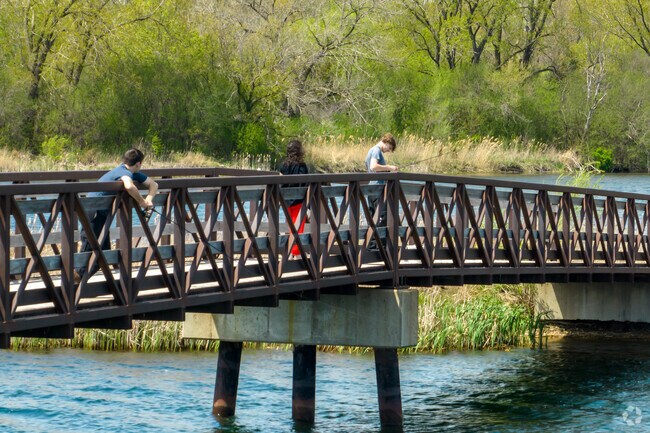 Keeneyville residents fishing off a wooden bridge at Mallard Lake