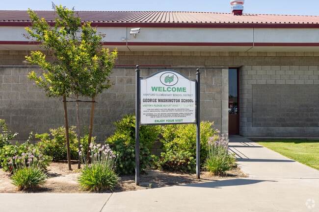 A sign outside the entrance of George Washington Elementary School welcomes parents.