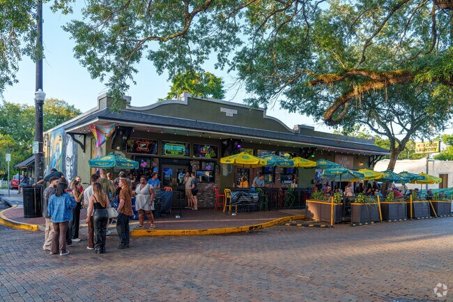 A crowd gathers around Burton's in Thornton Park at the Wine Walk and Art Festival.