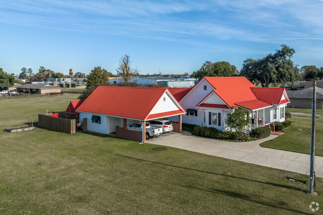 A one-story, Contemporary home with a detached garage and long driveway in Breaux Bridge.