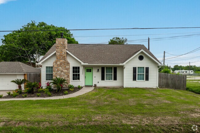 A quaint cottage sits along a street in central San Leon.