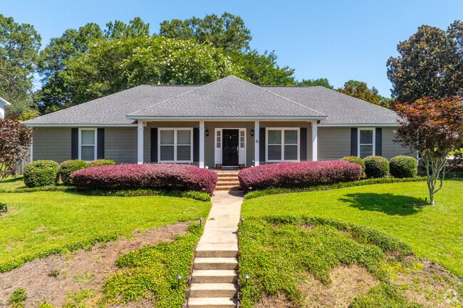 This Ranch with multiple roof lines sits high atop a small hill and looks down on its neighbors.