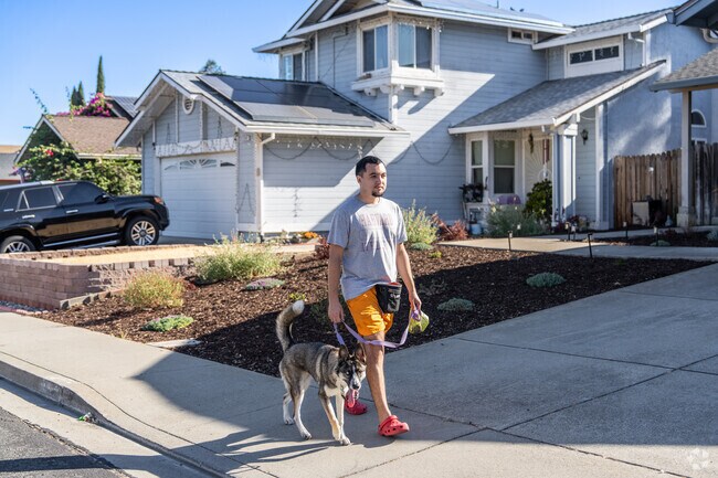A man strolls through Highland Meadows, enjoying quality time with his furry companion.